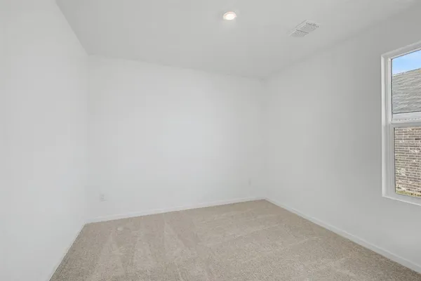 a view of an empty room and a window