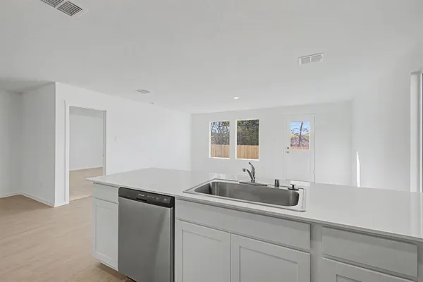 a kitchen with a sink and cabinets