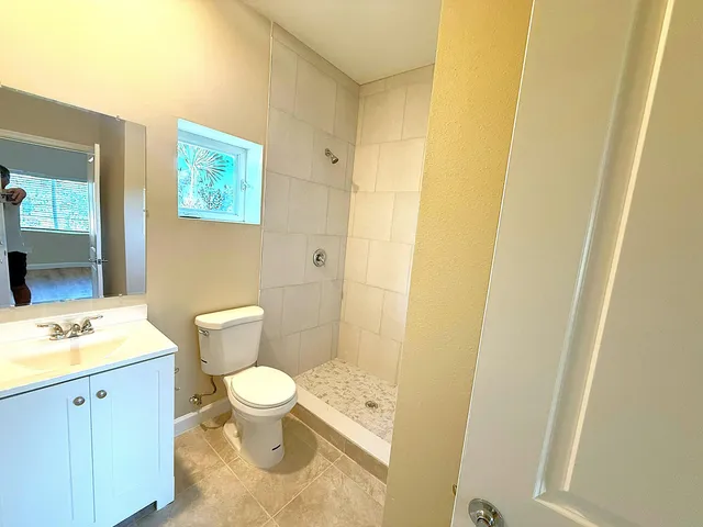 a bathroom with a sink a toilet and a mirror