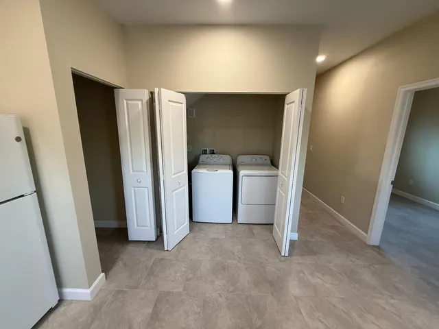 a view of livingroom with furniture and refrigerator