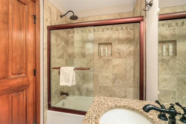 a bathroom with a shower and a sink