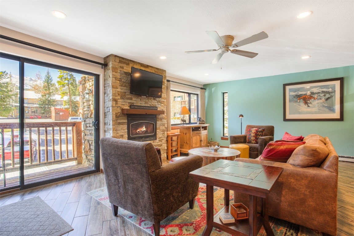 350 4 O Clock Road, Unit C Breckenridge, CO 80424 - Photo 4 of 29 a living room with furniture a flat screen tv and a large window