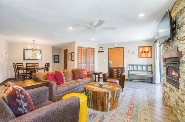 a living room with furniture a fireplace and a flat screen tv