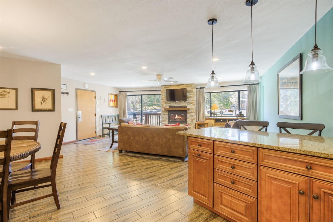 350 4 O Clock Road, Unit C Breckenridge, CO 80424 - Photo 9 of 29 a kitchen with granite countertop a table chairs and wooden floor