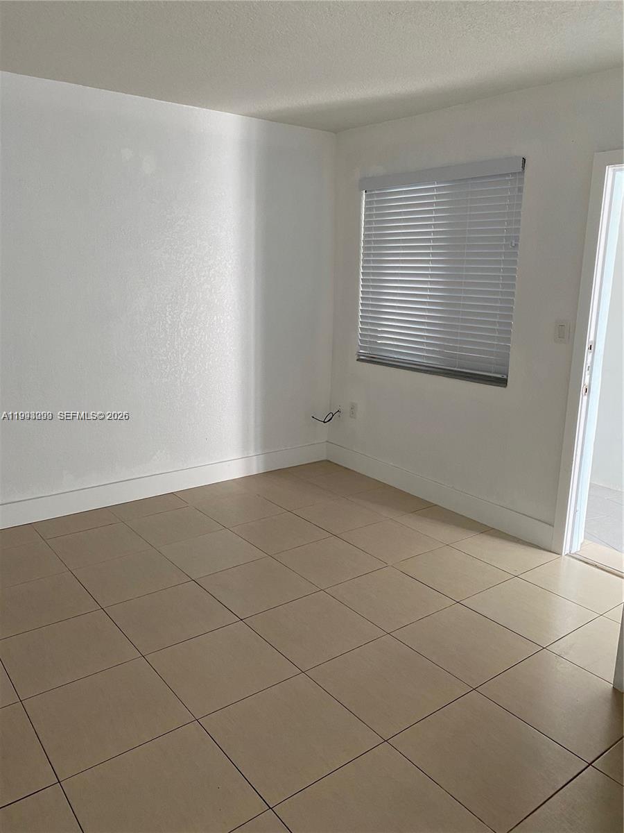 35 Southwest 21st Avenue, Unit 4 Miami, FL 33135 - Photo 6 of 6 an empty room with a empty space and window