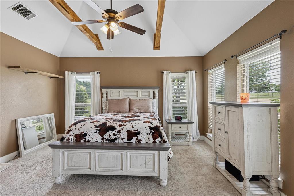 6251 Hayes Road Midlothian, TX 76065 - Photo 16 of 30 a bedroom with a bed and a chandelier