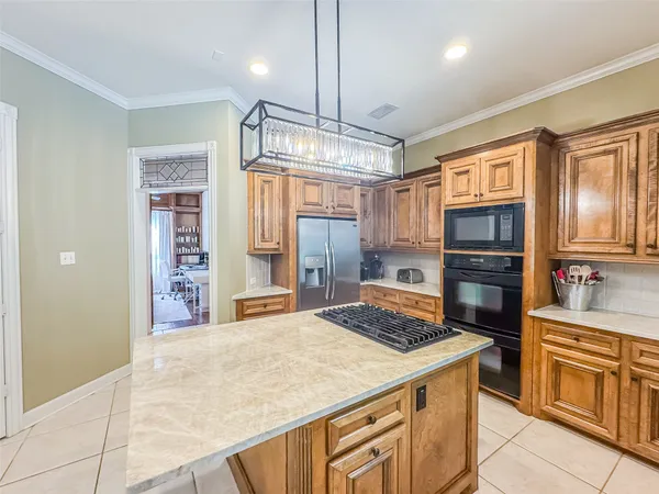 a large white kitchen with a large window