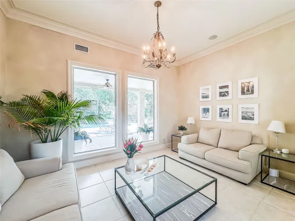 a living room with furniture and a chandelier
