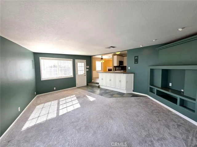 a view of empty room with a fireplace