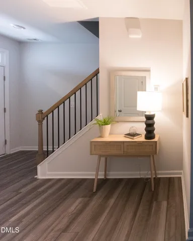 a view of a bedroom with wooden floor and a sink
