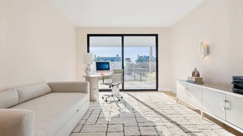 a large bed sitting in a bedroom next to a window