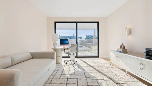 a large bed sitting in a bedroom next to a window