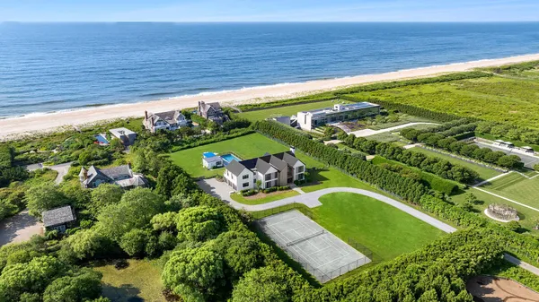 an aerial view of a residential houses with outdoor space and street view