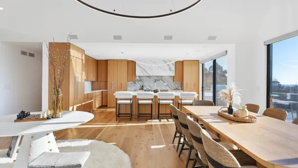 a dining room with furniture a chandelier and wooden floor