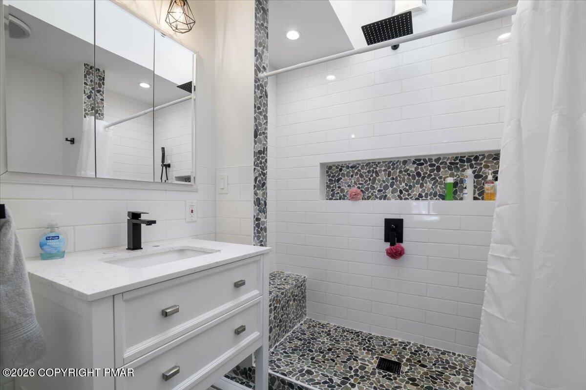 5873 Decker Road Bushkill, PA 18324 - Photo 7 of 57 a bathroom with a sink and a mirror