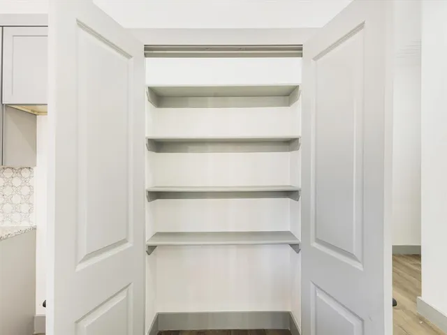 a bathroom with a granite countertop sink a toilet and bathtub