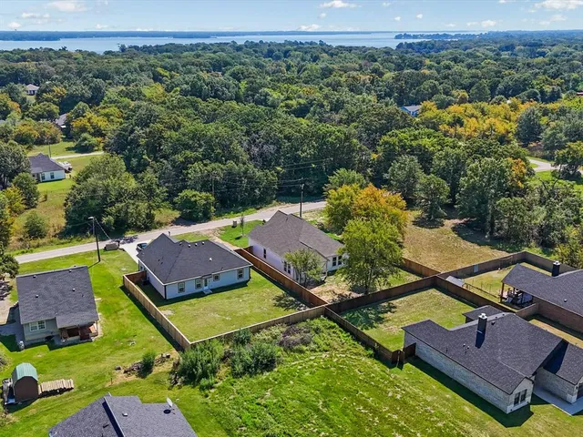 an aerial view of a house with a garden and swimming pool