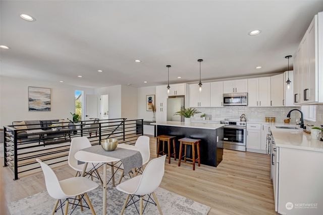 a large kitchen with a table and chairs in it
