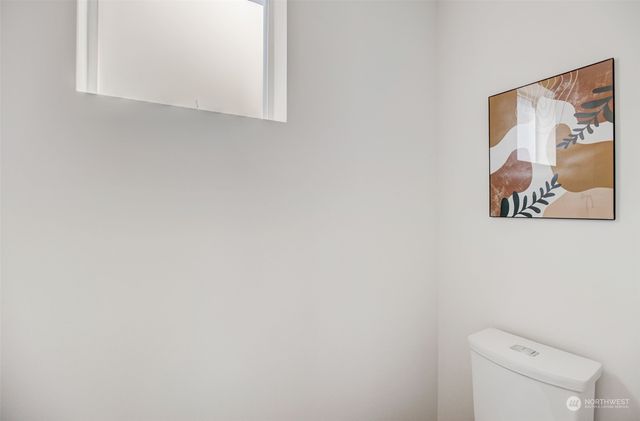 a bathroom with a toilet and a shower curtain