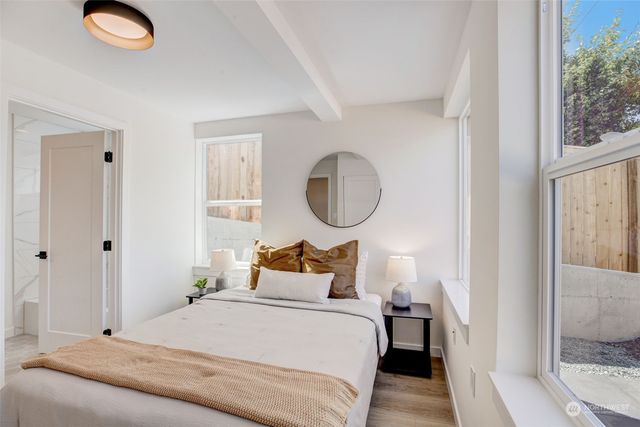 a bedroom with a bed and a painting on the wall