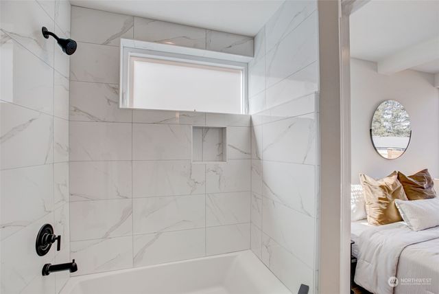 a bathroom with a shower a mirror and a shower