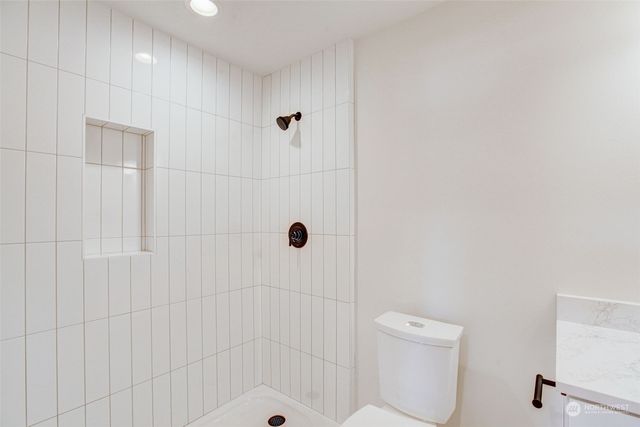 a bathroom with a shower and toilet