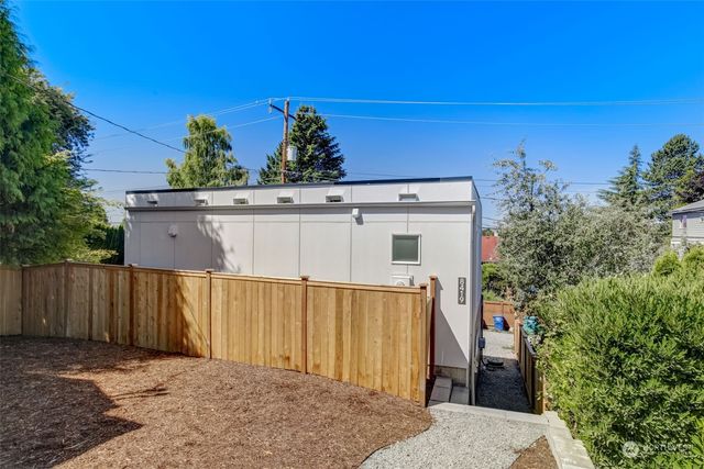 a view of a house with a wooden fence