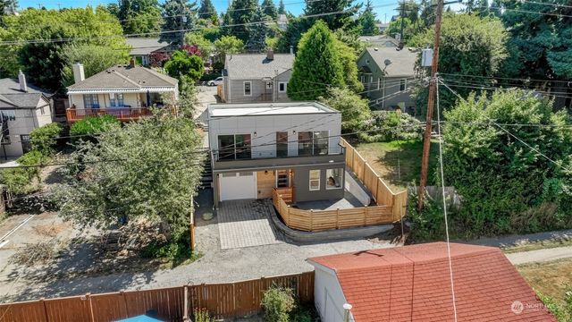 an aerial view of a house with swimming pool and patio