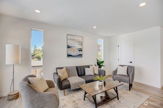 a living room with furniture and a potted plant