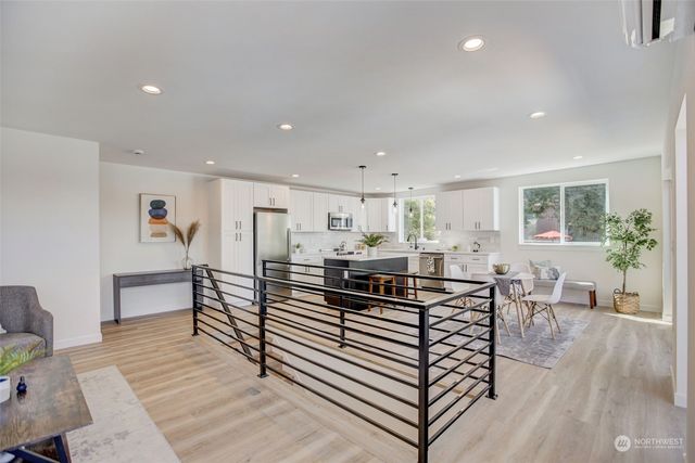 a living room with furniture a wooden floor and next to a window
