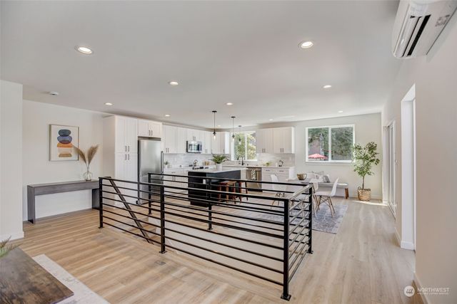 a living room with furniture a wooden floor and a potted plant