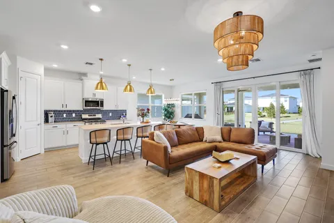 a bedroom with a large bed and a chandelier