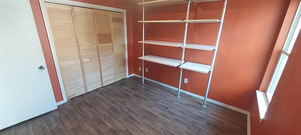 7340 Skillman Street, Unit 512 Dallas, TX 75231 - Photo 11 of 15 a view of an empty room with wooden floor and closet