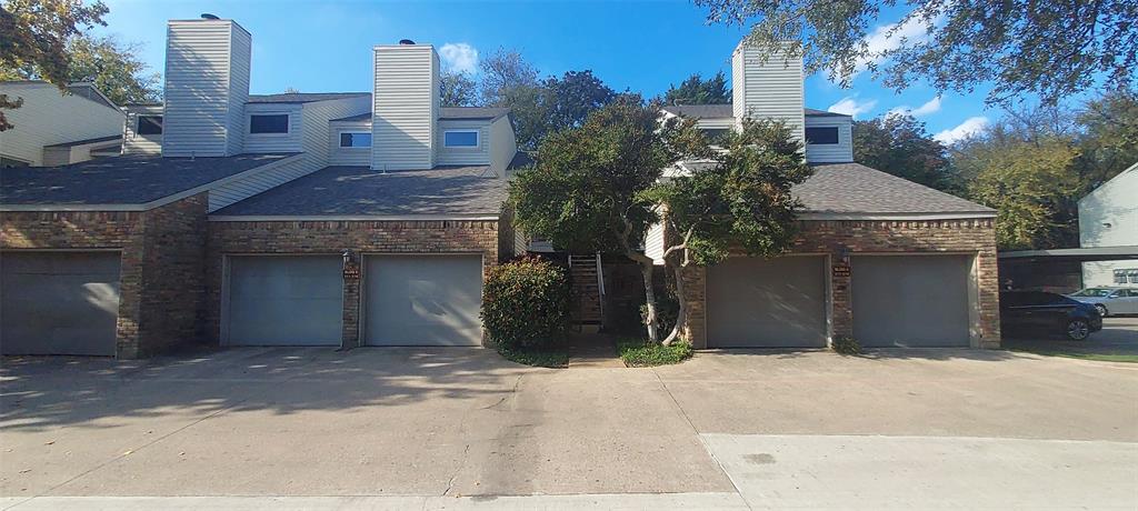 7340 Skillman Street, Unit 512 Dallas, TX 75231 - Photo 2 of 15 a front view of a house with a yard and garage