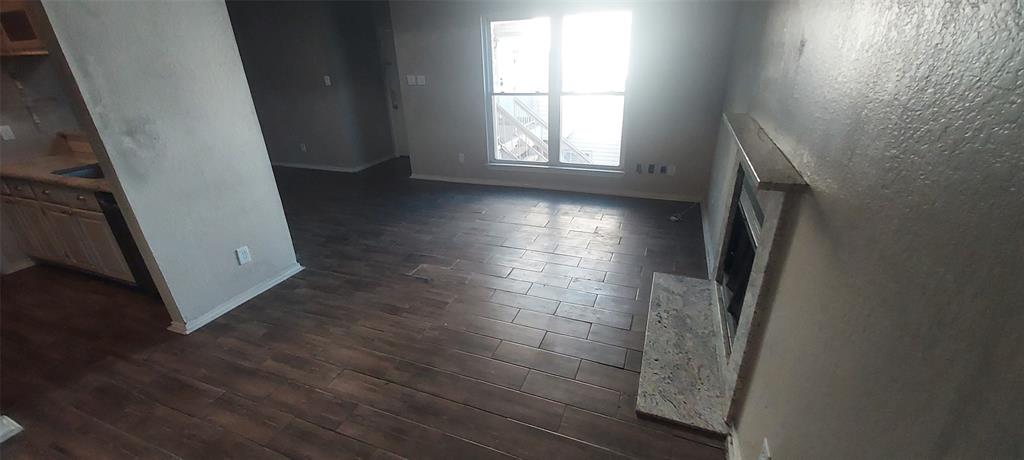 7340 Skillman Street, Unit 512 Dallas, TX 75231 - Photo 6 of 15 an empty room with wooden floor and a window