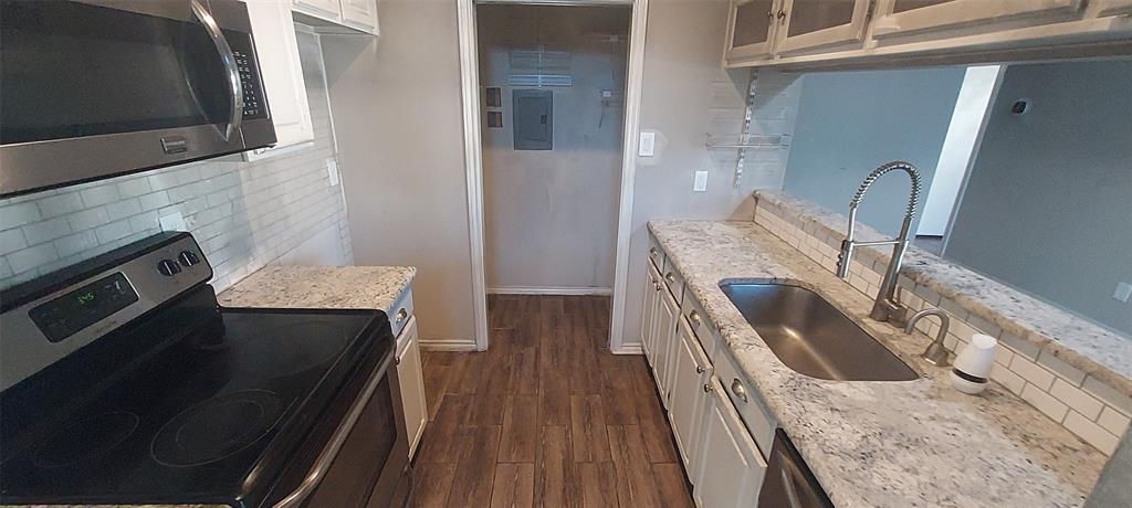7340 Skillman Street, Unit 512 Dallas, TX 75231 - Photo 7 of 15 a kitchen with a sink stove and refrigerator