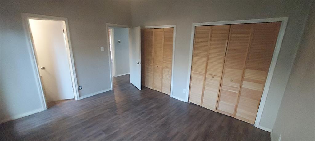 7340 Skillman Street, Unit 512 Dallas, TX 75231 - Photo 9 of 15 an empty room with wooden floor and entrance