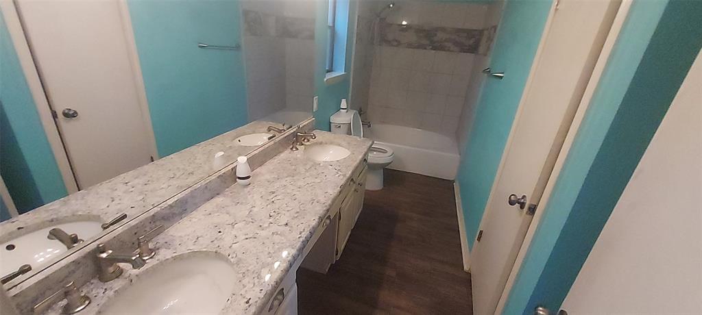 7340 Skillman Street, Unit 512 Dallas, TX 75231 - Photo 10 of 15 a bathroom with a granite countertop double vanity and a mirror