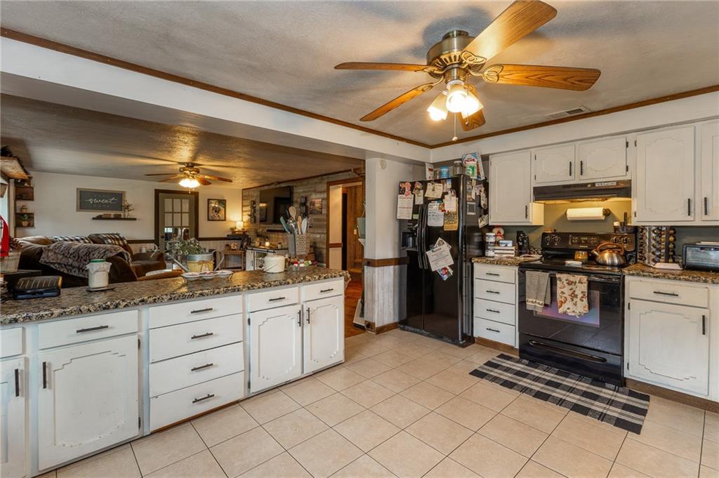 118 Eau Claire Road Boyers, PA 16020 - Photo 13 of 24 a kitchen with kitchen island granite countertop appliances cabinets and a sink