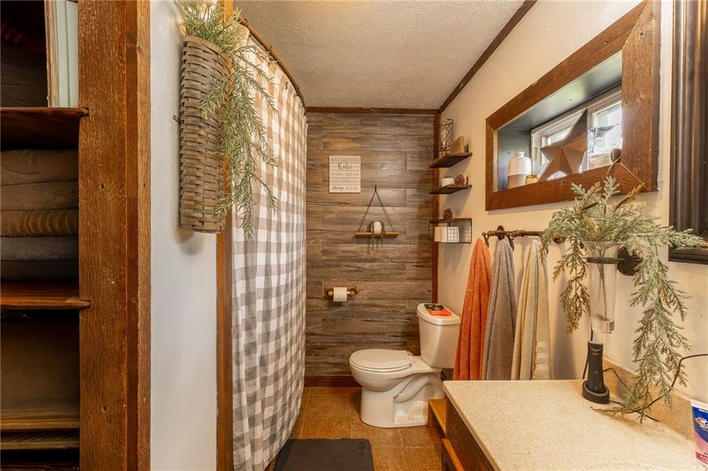 118 Eau Claire Road Boyers, PA 16020 - Photo 22 of 24 a bathroom with a shower and a toilet