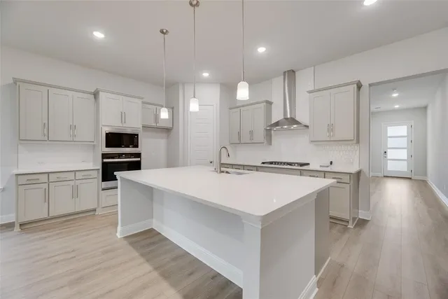 a kitchen with a sink a counter top space and appliances