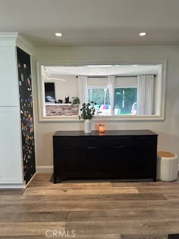 a living room with a fireplace and a large window