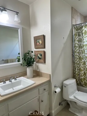a bathroom with a sink toilet and mirror