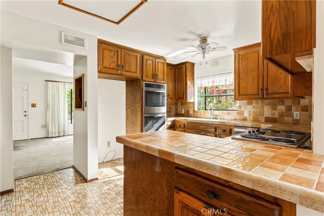 a kitchen with stainless steel appliances granite countertop a sink and cabinets