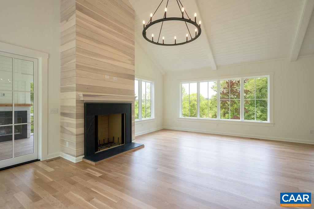 25 Old Farm Road Charlottesville, VA 22903 - Photo 6 of 49 an empty room with wooden floor exposed radiator and windows