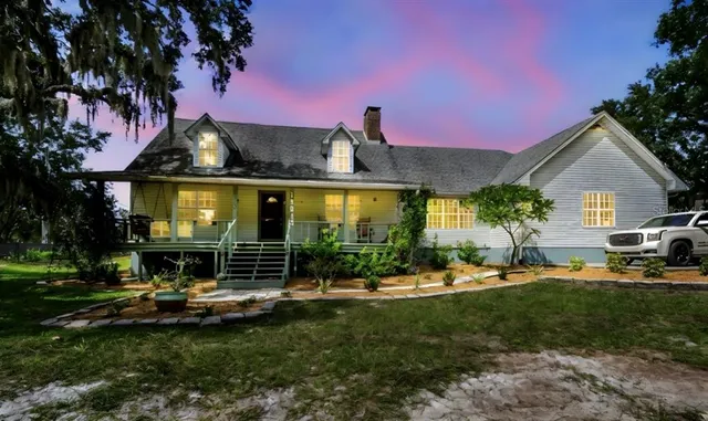 a front view of a house with a yard table and chairs