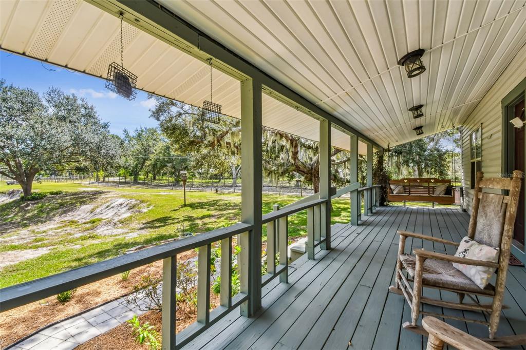 15019 Carlton Lake Road Wimauma, FL 33598 - Photo 11 of 89 a view of a porch with furniture and wooden floor