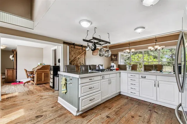 a kitchen with white cabinets and white appliances