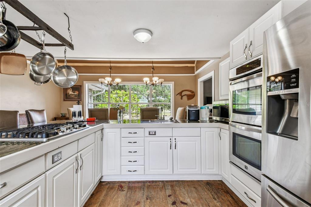 15019 Carlton Lake Road Wimauma, FL 33598 - Photo 18 of 89 a kitchen with white cabinets and white appliances