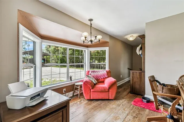 a bedroom with a bed flat screen tv and a window